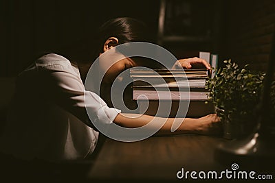 Young Asian girl sleeping be tired by the study. Stock Photo