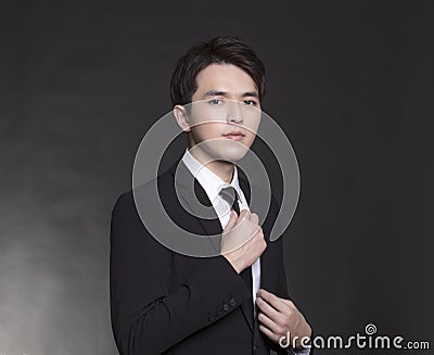 Young Asian handsome Business man in black suit Stock Photo