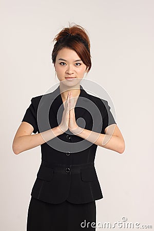 Young Asian lady showing a welcoming gesture Stock Photo