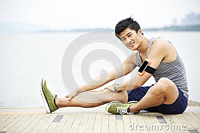 Young asian man exercising outdoors Stock Photo