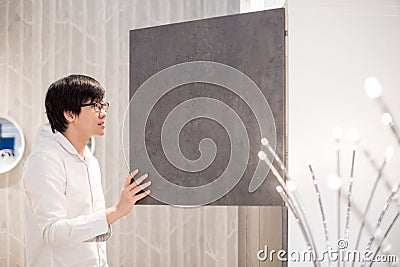 Young Asian man opening modern wardrobe choosing furniture in wa Stock Photo