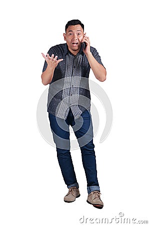 Young Man Talking on Phone, Shocked Worried Expression Stock Photo