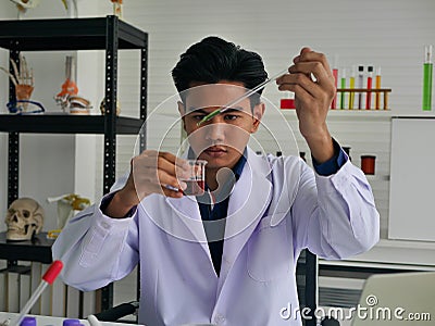 The young asian medical doctor finding the cure for outbreak spread virus disease in his medical science Stock Photo