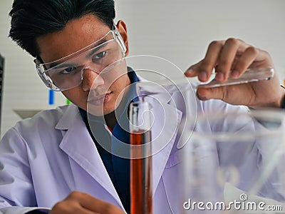 The young asian medical doctor finding the cure for outbreak spread virus disease in his medical science Stock Photo