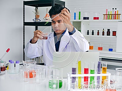 The young asian medical doctor finding the cure for outbreak spread virus disease in his medical science Stock Photo