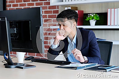 Young asian office man struggle with computer, Frustrated asian business man looking at computer while working at office, Business Stock Photo