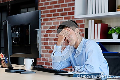 Young asian office man struggle with computer, Frustrated asian business man looking at computer while working at office, Business Stock Photo