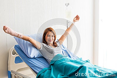 Asian patient woman lying at hospital bed with saline sign for cheerful. Drop of saline solution to help patient Stock Photo
