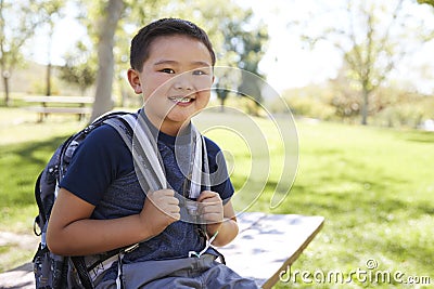 Young Asian schoolboy with backpack smiling to camera Stock Photo