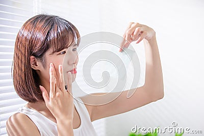 Woman use oil blotting paper Stock Photo