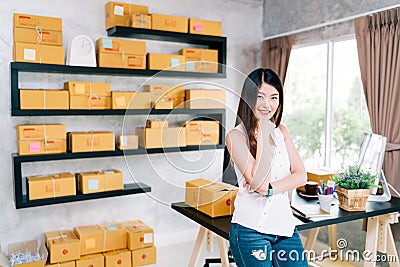 Young Asian small business owner at home office, online marketing packaging and delivery scene Stock Photo