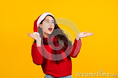 Young Asian surprised and shocked. Asian woman wear Santa Claus Christmas red hat spread hands Stock Photo