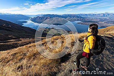 Young asian traveler backpack hiking on Roys peak track, Wanaka, South Island, New Zealand Stock Photo