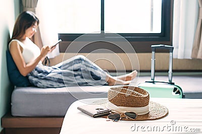 Young Asian traveler woman relaxing in hotel room after check-in. Travel and summer holiday concept Stock Photo