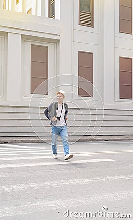 Young Asian traveling backpacker having fun in the city Stock Photo