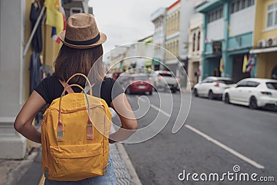 Young Asian traveling backpacker in Khaosan Road outdoor market in Bangkok, Thailand, Tourist, Travel and backpack concept. Stock Photo