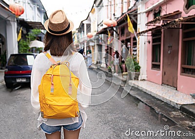 Young asian traveling backpacker in Khaosan Road outdoor market in Bangkok, Thailand Stock Photo