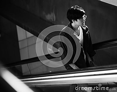 Young asian using escalator routine life Stock Photo