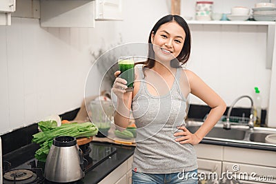 Young asian woman enjoy healthy vegetarian smoothie for weight l Stock Photo