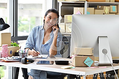 Young Asian woman entrepreneur/ Business owner working with computer at home Stock Photo