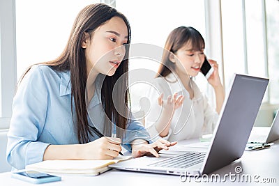 Young asian woman focusing on getting work done Stock Photo