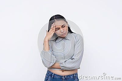 A young asian woman has an excruciating headache. Feeling a bad migraine. Isolated on a white background Stock Photo