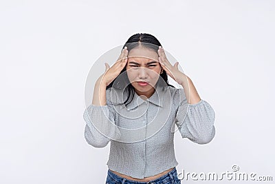 A young asian woman has an excruciating headache. Feeling a bad migraine. Isolated on a white background Stock Photo