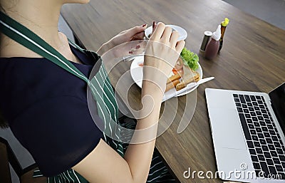 Young Asian woman hold cup of black coffee Stock Photo