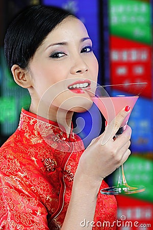 Young asian woman holding a glass of cocktail Stock Photo