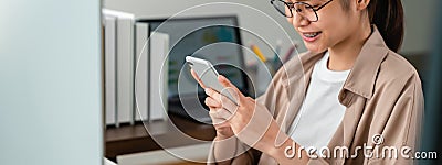 Young Asian woman holding smartphone and using online social lifestyles. Stock Photo