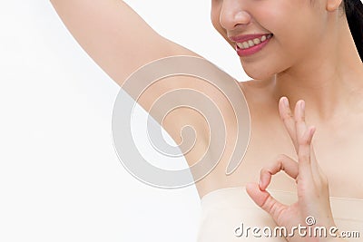 Young Asian woman lifting hands up to show off clean and hygienic armpits or underarms and giving okay sign Stock Photo