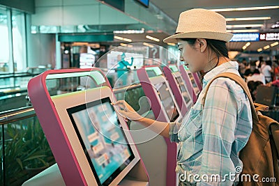 Young Asian woman at self service transfer Stock Photo