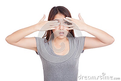 Young Asian woman shock peeking though her fingers Stock Photo