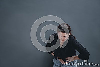 Young asian woman suffering from stomach painful illness feeling unwell Stock Photo