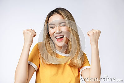 Young Asian woman with surprised excited happy screaming. Cheerful girl with funny joyful face expression Stock Photo