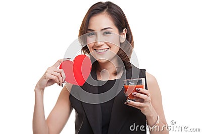 Young Asian woman with tomato juice and red heart. Stock Photo