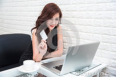 Young Asian woman use credit card for online shopping with laptop. Business and Banking payment concept. Price sale and promotion Stock Photo
