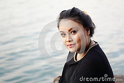 Young asian woman by the water Stock Photo