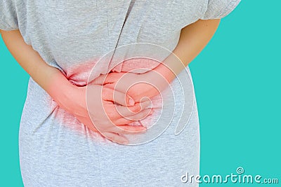 Young asian women hold hands in painful areas which may be caused by gastritis, menstruation period cramp, abdominal pain, stomach Stock Photo