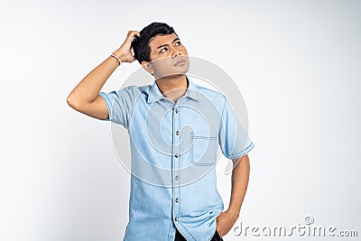 Young Asians hold their heads when thinking Stock Photo
