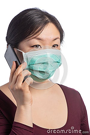 young asiatic woman wearing a protection mask making a phone call on a white background Stock Photo