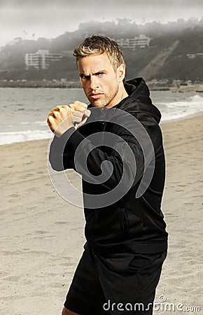 Young athlete boxer at beach Stock Photo