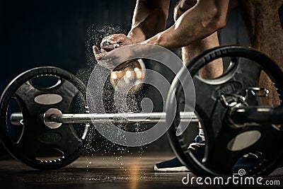 Young athlete getting ready for weight lifting training. Powerlifter hand in talc preparing to bench press Stock Photo