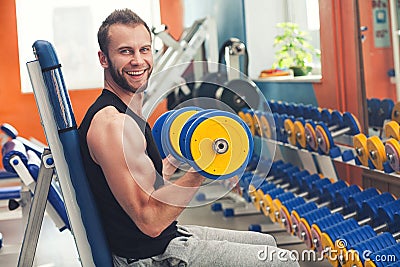 Young athlete lifting weights in the gym Stock Photo