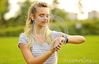 Athlete woman at park checking her smartwatch Stock Photo