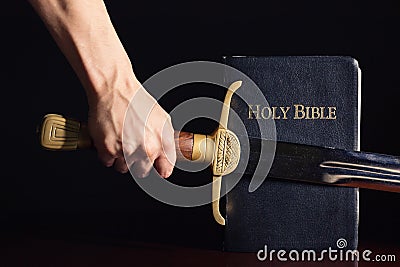 Young Athletic Man with His Bible and Sword Stock Photo