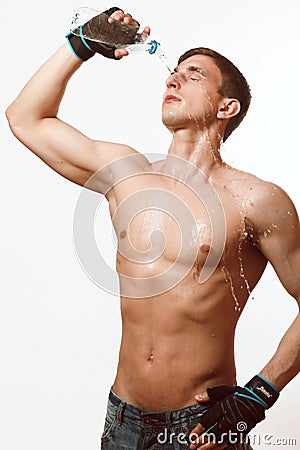 Young athletic man pours water Stock Photo