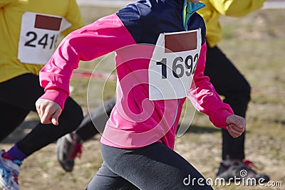 Young athletic runners on a race. Outdoor circuit Stock Photo