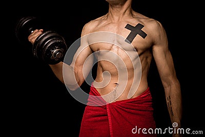 Young athletic shirtless man working out on black background Stock Photo