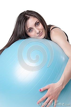 Young athletic woman exercised with a blue stability ball Stock Photo